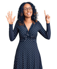 Young african american woman wearing casual clothes and glasses showing and pointing up with fingers number six while smiling confident and happy.