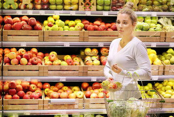Woman buying fruits and vegetables at the market