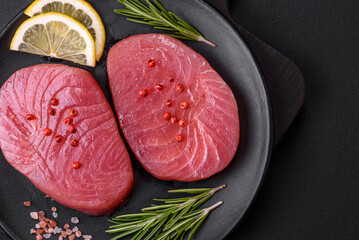 Two fresh slices of raw tuna fillet with spices and herbs