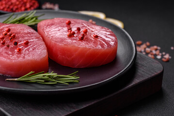 Two fresh slices of raw tuna fillet with spices and herbs