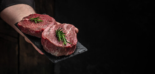Beef medallions with rosemary and spices, Raw beef meat steak Tenderloin fillet on a dark background. banner, menu, recipe place for text, top view - obrazy, fototapety, plakaty