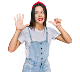 Young hispanic girl wearing casual clothes showing and pointing up with fingers number six while smiling confident and happy.