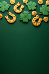 Vertical banner for St. Patrick's Day on green background. Coins, horseshoes, four-leaf clover as...