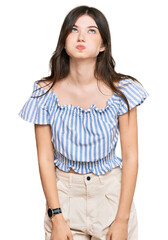 Fototapeta premium Young beautiful caucasian girl wearing casual clothes puffing cheeks with funny face. mouth inflated with air, crazy expression.
