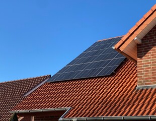 Installed solar system on a red house roof, energy transition