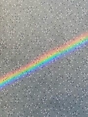 Rainbow on the floor of an office carpet, created by the sun shining in the window