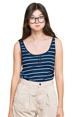 Fototapeta premium Young beautiful caucasian girl wearing casual clothes and glasses puffing cheeks with funny face. mouth inflated with air, crazy expression.