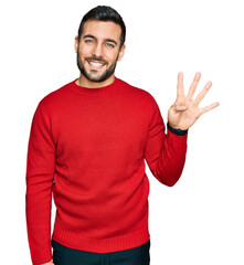Young hispanic man wearing casual clothes showing and pointing up with fingers number four while smiling confident and happy.