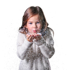 Christmas, x-mas, people, happiness concept - happy girl in winter clothes blowing on snow