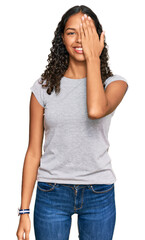 Fototapeta premium Young african american girl wearing casual clothes covering one eye with hand, confident smile on face and surprise emotion.