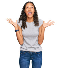 Young african american girl wearing casual clothes celebrating crazy and amazed for success with...