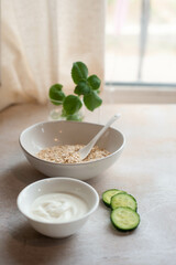 Morning composition of healthy breakfast ingredients. Oatmeal, cucumber. High quality photo