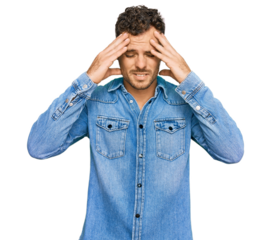 Young hispanic man wearing casual denim jacket with hand on head for pain in head because stress. suffering migraine.
