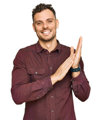 Young hispanic man wearing casual clothes clapping and applauding happy and joyful, smiling proud hands together - obrazy, fototapety, plakaty