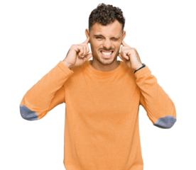 Young hispanic man wearing casual clothes covering ears with fingers with annoyed expression for the noise of loud music. deaf concept.