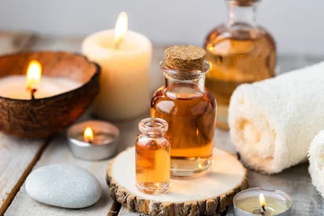 Keuken foto achterwand Spa Concept of spa treatment in salon with pure organic natural oil. Atmosphere of relax, detention. Aromatherapy, candles, towel, wooden background. Skin care, body gentle treatment