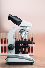 Modern microbiology microscope on table in laboratory.
