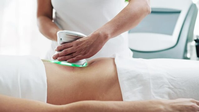 Video of cosmetologist makes the procedure an ultrasonic cleaning of skin of a beautiful woman on the spa center.