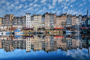 Honfleur, beautiful city in France, the harbor at sunrise, reflection on the river
