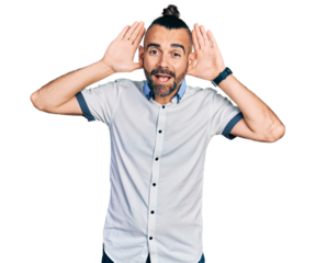 Hispanic man with ponytail wearing casual white shirt smiling cheerful playing peek a boo with hands showing face. surprised and exited