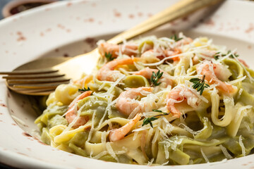 pasta fettuccine or tagliatelle with seafood rich cream. Cooking mediterranean food with savory prawns,Restaurant menu, dieting, cookbook recipe top view