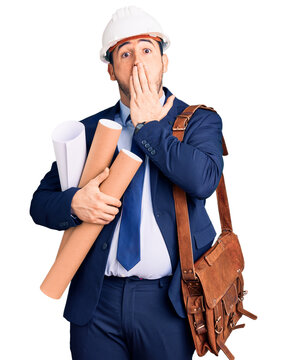 Young hispanic man wearing architect hardhat and leather bag holding blueprints covering mouth with hand, shocked and afraid for mistake. surprised expression