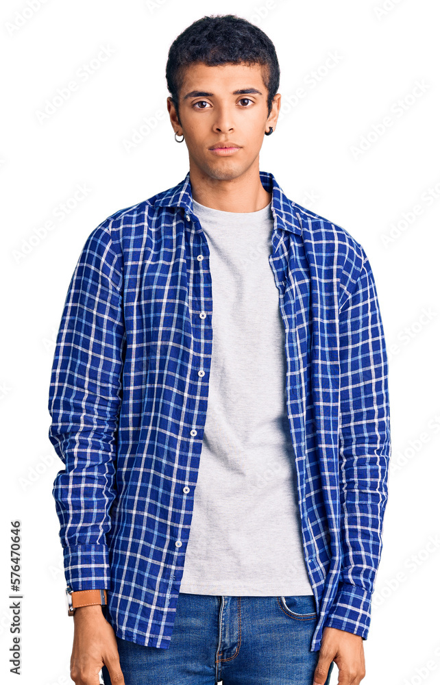 Poster Young african amercian man wearing casual clothes relaxed with serious expression on face. simple and natural looking at the camera.