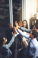 Fototapeta Were going to succeed no matter what. Shot of a group of businesspeople high fiving in an office. obraz