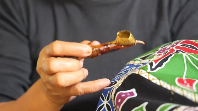 Making batik tulis Solo.  The technique of making batik by writing using a canting tool. Canting consists of nyamplung, cucuk, gagang or handles made of copper, bamboo and wax