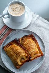 Breakfast with black coffee and sweet French dessert, baked apple cake, Normandy region, France, close up