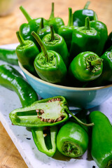Fresh green mild padron pepper pementos, ready for grill or to be fried with olive oil, traditional snack in Galicia, Spain.