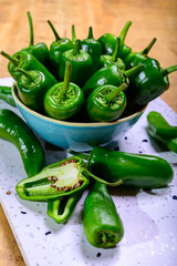 Fresh green mild padron pepper pementos, ready for grill or to be fried with olive oil, traditional snack in Galicia, Spain.