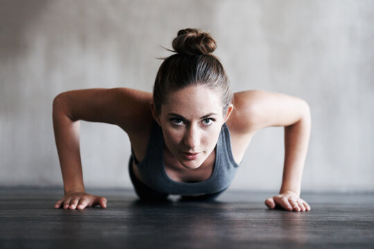 Its Tough, But Its Worth It. Shot Of A Woman Doing Pushups At The Gym.