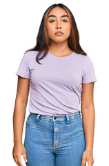 Obraz premium Young latin woman wearing casual clothes relaxed with serious expression on face. simple and natural looking at the camera.