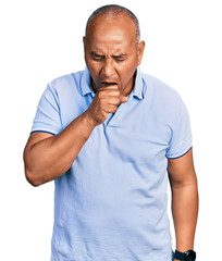 Hispanic middle age man wearing casual t shirt feeling unwell and coughing as symptom for cold or bronchitis. health care concept.