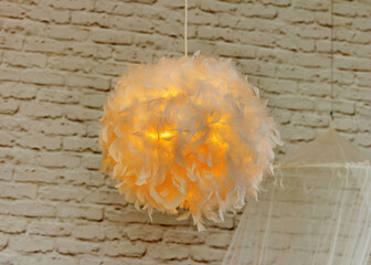 Modern lamp with abajur made of white feathers