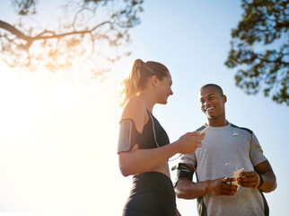 Buddy up for the best. Shot of a fit young couple working out together outdoors.