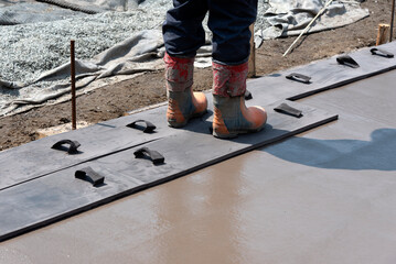 Workers stamping a concrete floor