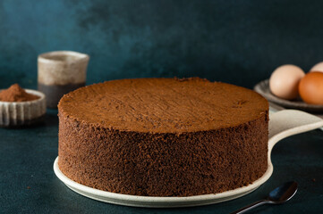 Homemade round chocolate sponge cake or chiffon cake. Sponge cake ingredients: eggs, flour and...