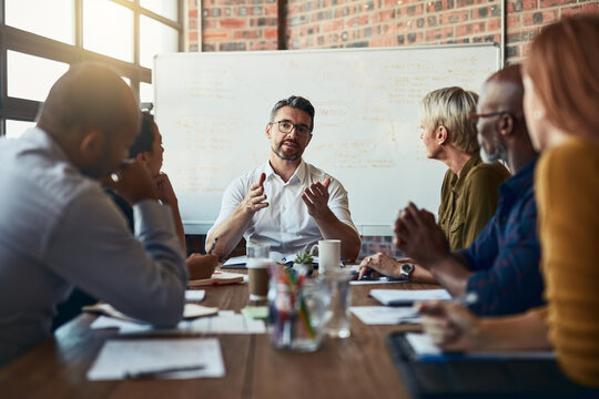 Getting into the details. Cropped shot of a mature businessman leading a meeting in the boardroom.