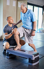 Just one more step. Cropped shot of a handsome personal trainer with a senior man.