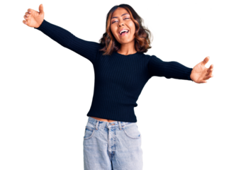 Young beautiful mixed race woman wearing casual clothes looking at the camera smiling with open arms for hug. cheerful expression embracing happiness.