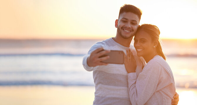 Couple, beach selfie and sunset love for happiness, save the date engagement announcement or mockup. Man, woman and take photograph at sea of happy holiday, peace or relax at ocean, travel or freedom - Powered by Adobe