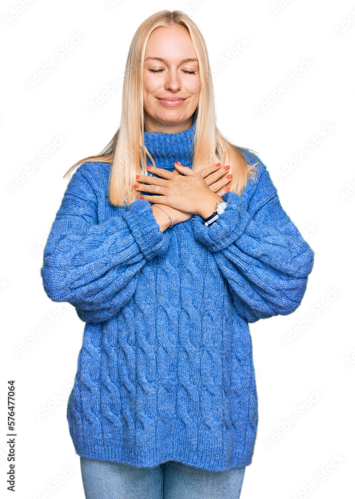 Canvas Prints young blonde girl wearing wool winter sweater smiling with hands on chest with closed eyes and grate