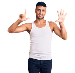 Young hispanic man wearing casual clothes showing and pointing up with fingers number seven while smiling confident and happy.