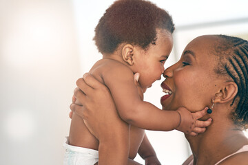 Fototapeta premium Smile, touch and nose with mother and baby for bonding, affectionate and connection in family home. Kindness, happiness and happy with black woman holding child for positive, growth and support