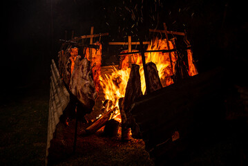 Argentinian beef ribs roasting around the fire made with quebracho wood