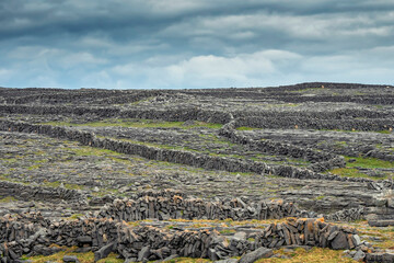 Maze of stone fences and blue cloudy sky. Aran Islands, county Galway, Ireland. Popular travel area with stunning nature scenery.