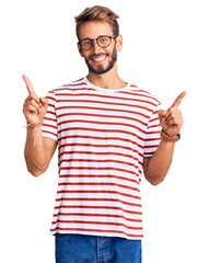 Handsome blond man with beard wearing casual clothes and glasses smiling confident pointing with fingers to different directions. copy space for advertisement