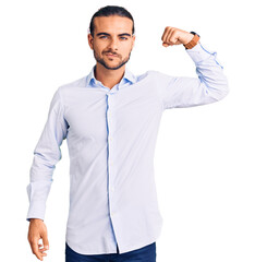 Young handsome man wearing business clothes strong person showing arm muscle, confident and proud...